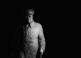 A powerful black and white photograph of a Winston Churchill statue in Paris, France.